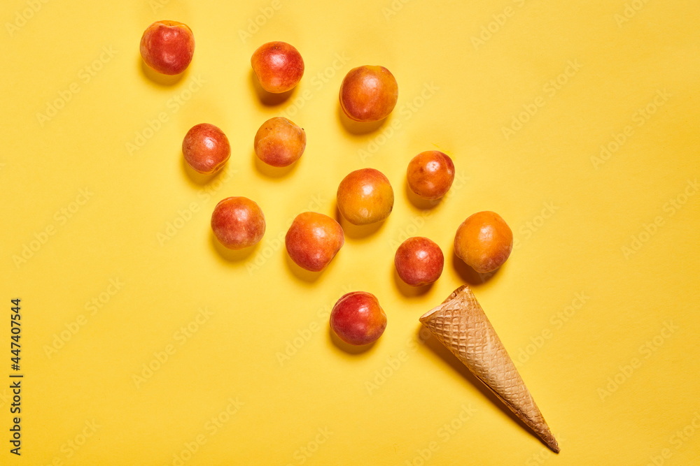 Group of scattered peaches and empty waffle cone Group of scattered peaches and empty waffle cone