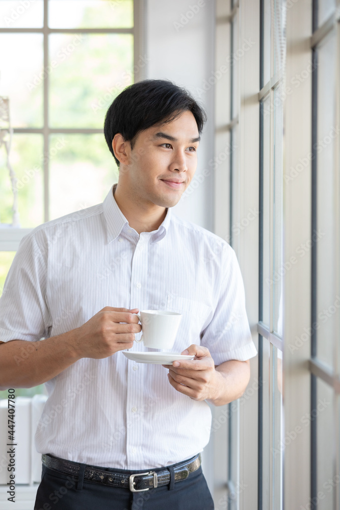 Image is Portrait. Asian man smiling scientist or researcher wearing white shirt and protective glassware holding coffee for research in laboratory or hospital. Concept research medical chemistry. Image is Portrait. Asian man smiling scientist or researcher wearing white shirt and protective glassware holding coffee for research in laboratory or hospital. Concept research medical chemistry.