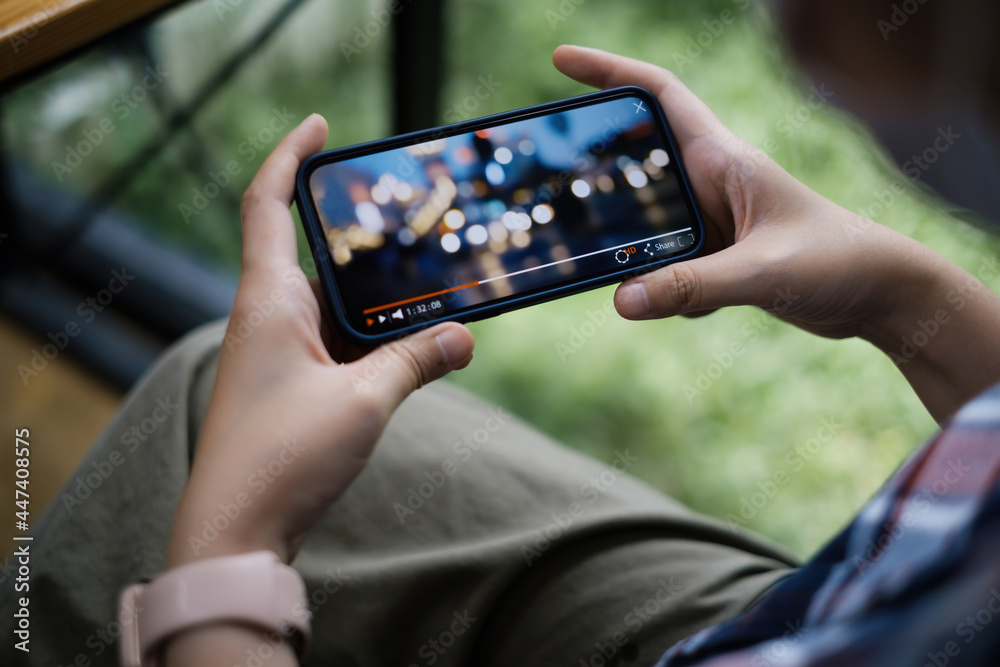 While quarantine a women watching live streaming by application on smartphone.