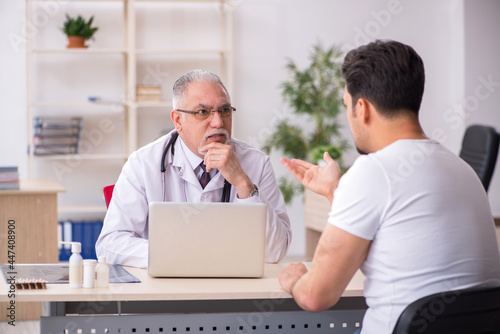 Young male patient visiting old male doctor