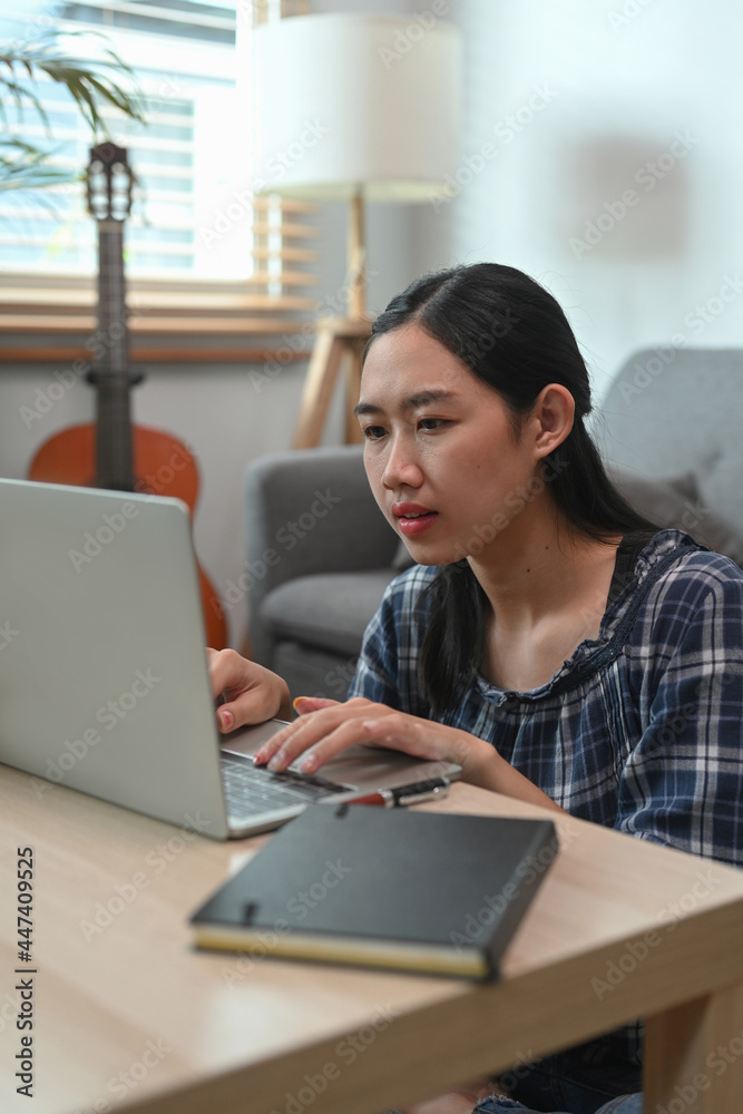 Young woman working with laptop computer at home. Young woman working with laptop computer at home.