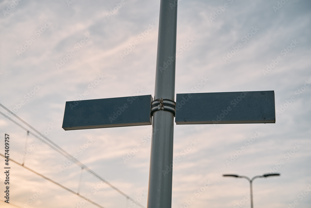 Two blank signs on the metal pole. Concept of two choses. Copy space for word or sign. Transportation announcement signs on the train station.