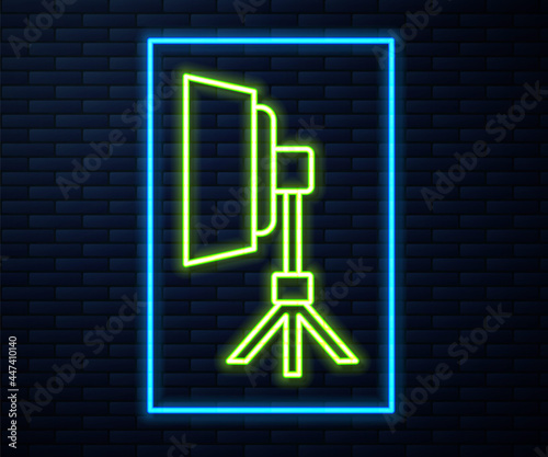Glowing neon line Studio light bulb in softbox icon isolated on brick wall background. Shadow reflection design. Vector