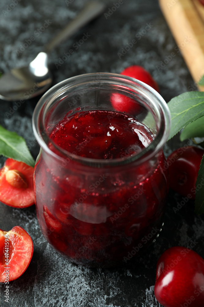 Cherry jam and ingredients on black smokey table Cherry jam and ingredients on black smokey table