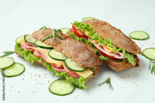 Ciabatta sandwiches and ingredients on white background