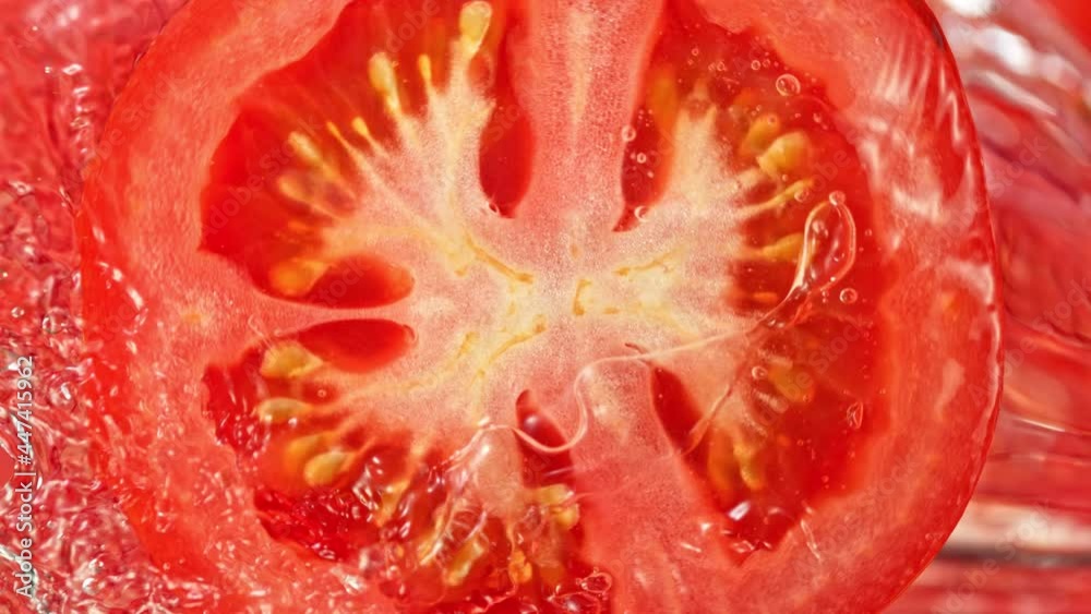 Super Slow Motion Shot of Splashing Water on Rotating Tomato Slice at 1000fps. Super Slow Motion Shot of Splashing Water on Rotating Tomato Slice at 1000fps.
