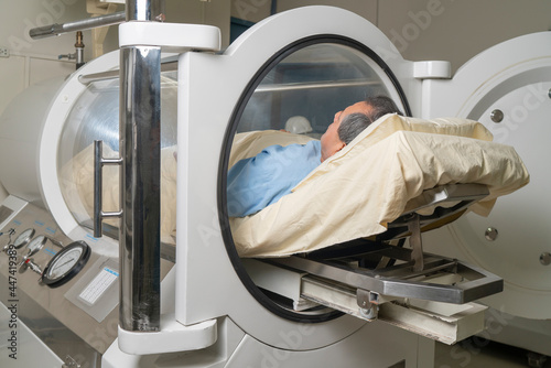 Man inside a machine for hyperbaric treatment