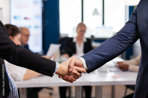 Satisfied businessman company employer wearing suit handshake new employee get hired at job interview, Man hr manager employ successful candidate shake hand at business meeting, placement concept photo