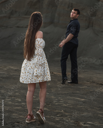 Couple of lovers outdoor on gray sand background