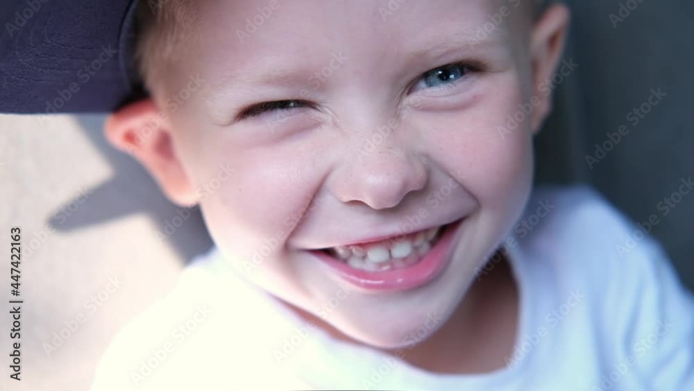 portrait of caucasian cute blue-eyed boy smiling and laughing while sitting in the car on a sunny day. Happy children travel by car. portrait of caucasian cute blue-eyed boy smiling and laughing while sitting in the car on a sunny day. Happy children travel by car.