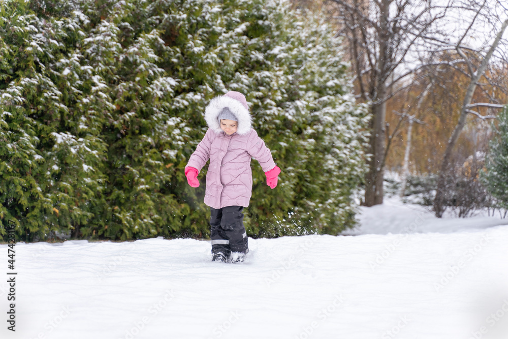 child walks in the park in winter