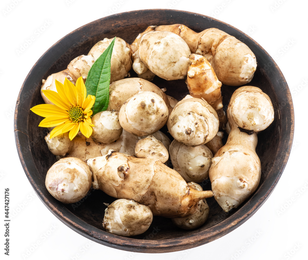 Jerusalem artichoke roots with leaves and flower of Jerusalem artichoke isolated on white background. Jerusalem artichoke roots with leaves and flower of Jerusalem artichoke isolated on white background.