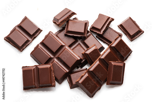 Pieces of dark chocolate bar isolated on white background. Sweet food is made of cocoa and sugar.