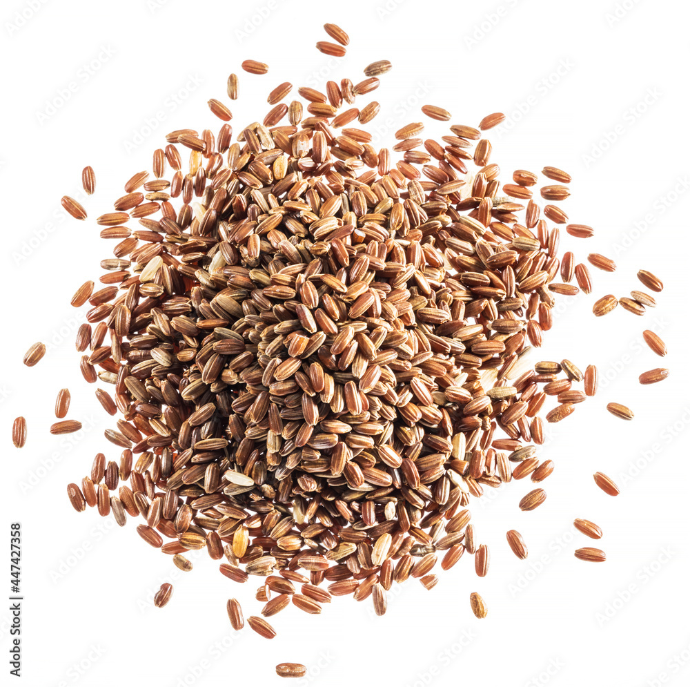 Brown rice heap - whole grain rice with outer hull or husk. Top view.