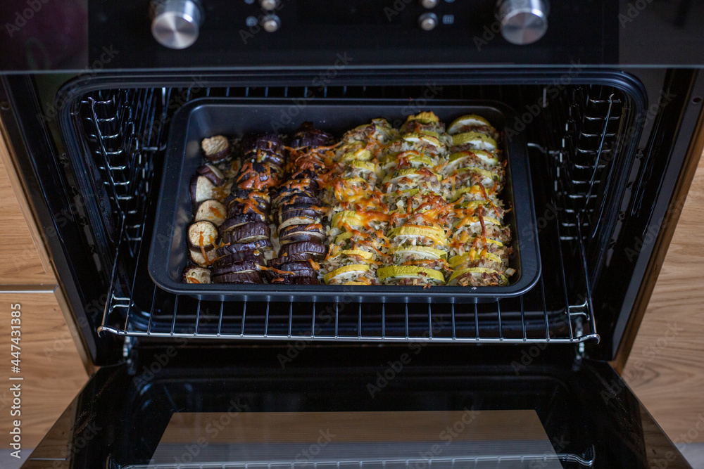 Oven baked zucchini and eggplant with cheese and rice. Vegetable casserole. Vegetarian dish