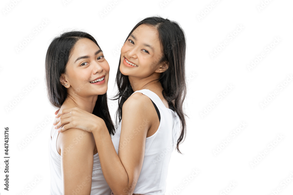 Happy brightful positive moments of two girls smiling with best friends indoors Happy brightful positive moments of two girls smiling with best friends indoors