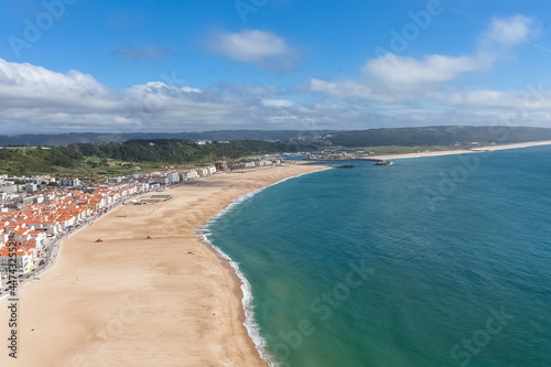 Fantastic aerial view of the beach and town of Nazaré and the town from the viewpoint of the touristic old town of Nazaré, atlantic ocean and sky