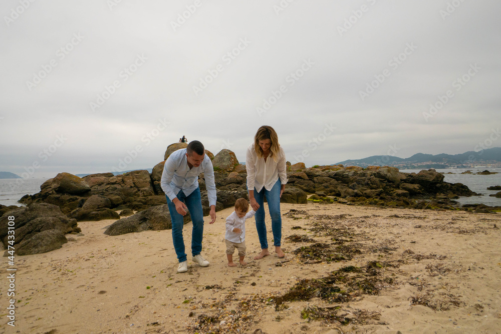 Happy family and child on beach