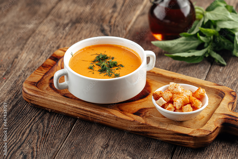 Lentil cream soup with dill and croutons on wooden background Lentil cream soup with dill and croutons on wooden background