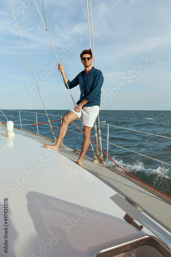 Young man resting on his yacht in sea or ocean