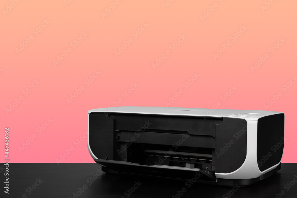 Compact home laser printer against pink background Compact home laser printer against pink background