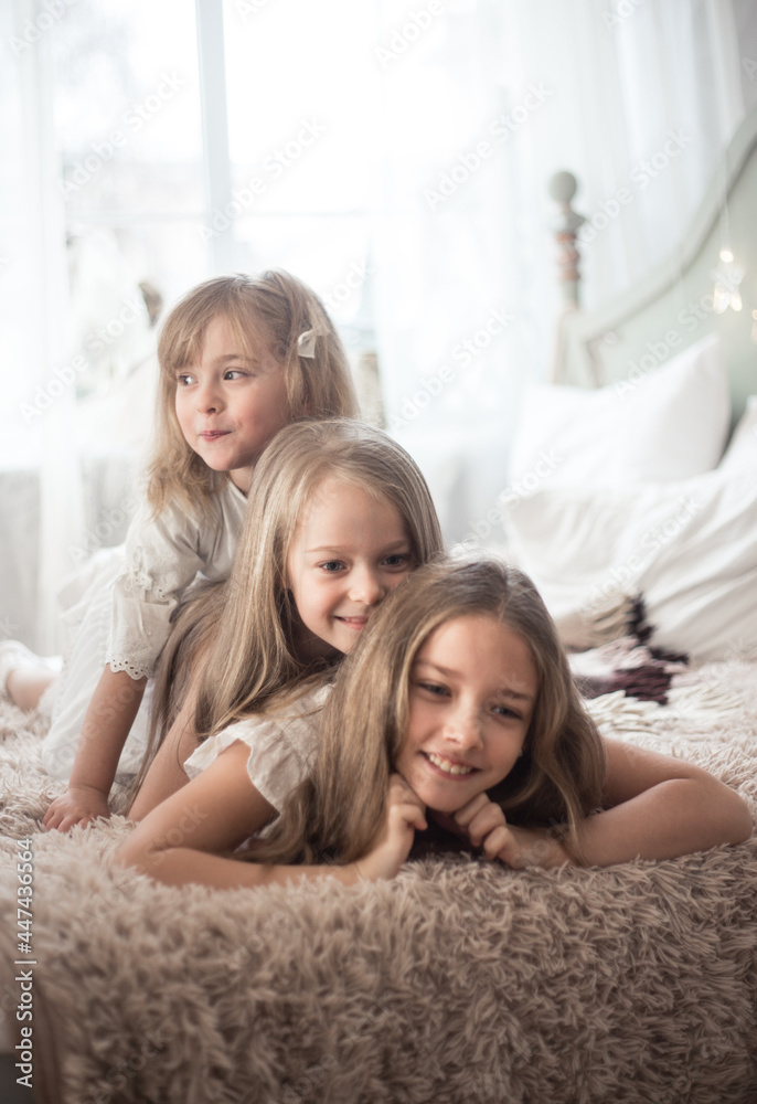 Little girls sisters in the morning in bed. Vintage style, Christmas holidays.
