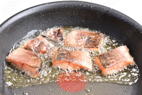 Sun-dried snakehead fish fried in a pan with vegetable oil