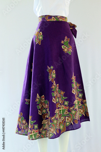 Women's purple wrapped batik skirt with ethnic motifs looks beautiful, simulated worn on a mannequin.