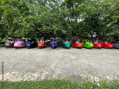 Many colorful taxi tuk tuks are lined up waiting to serve the journey.