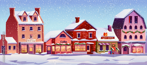 Christmas landscape street with decorated houses at day time, snowfall, snowy weather. Vector Xmas home buildings with chimneys, snow on ground, cafes and shops, urban city exterior © Sensvector