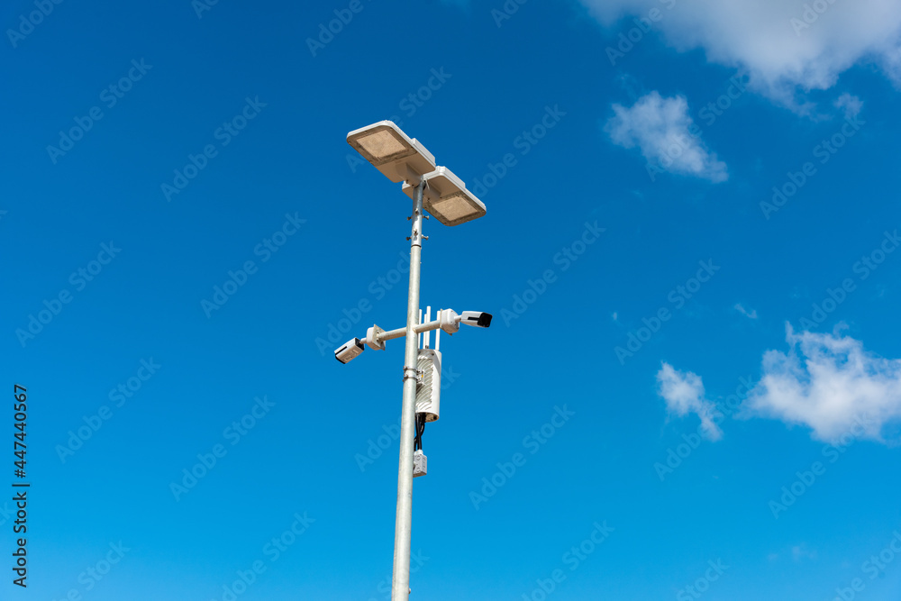 CCTV camera with blue sky background. Close-up of outdoor surveillance cameras on a street pole, Ensuring security on the street.. CCTV camera with blue sky background. Close-up of outdoor surveillance cameras on a street pole, Ensuring security on the street..