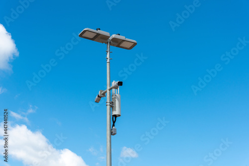 CCTV camera with blue sky background. Close-up of outdoor surveillance cameras on a street pole, Ensuring security on the street..