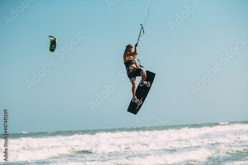 A kite surfer rides the waves