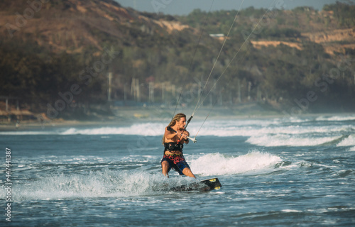 A kite surfer rides the waves