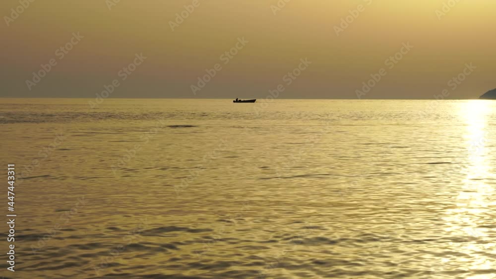 Boat sailing on sea horizon at sunset golden hour, creamy minimalist seascape panorama Boat sailing on sea horizon at sunset golden hour, creamy minimalist seascape panorama
