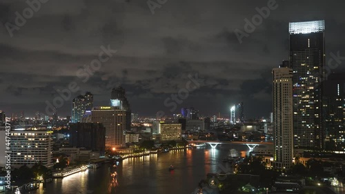 Wallpaper Mural Timelapse of Bangkok, Thailand at Night, Shiny Illuminated Buildings and Lights on Chao Phraya River With Cloudy Sky Torontodigital.ca