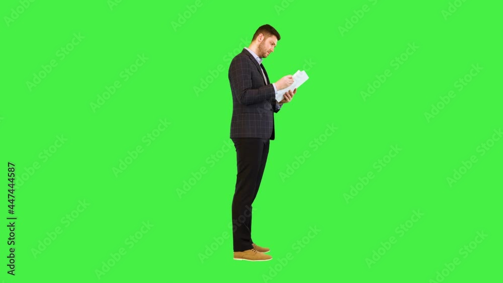 Focused serious businessman boss read document, report or contract Focused business man hold papers on a Green Screen, Chroma Key. Focused serious businessman boss read document, report or contract Focused business man hold papers on a Green Screen, Chroma Key.