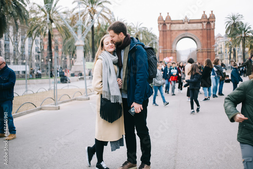 Cheerful couple kissing in Barcelona street