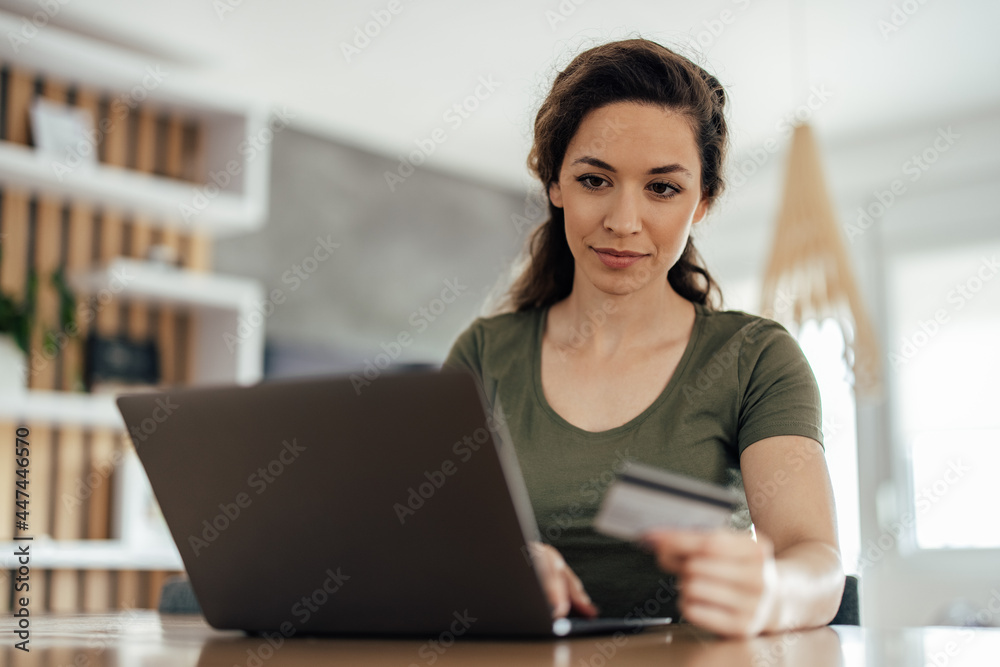 Fototapeta premium Young woman, making sure everything is fine in her bank.