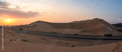 Sand dunes in Badr, Madinah, Saudi Arabia at sunset with the highway running through them