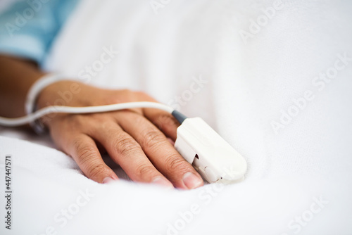 Closeup of hand with finger pulse oximeter