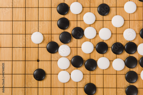 Desk for board game Go or Weiqi  and black and white bones. Traditional asian strategy boardgame photo