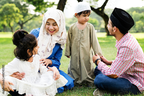 Muslim family having a good time outdoors photo