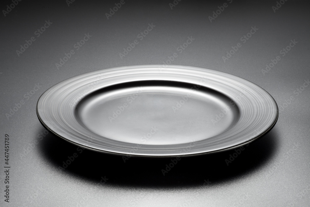 Empty black plate on black background. Empty black plate on black background.