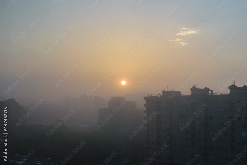 Wide cityscape shot with fog, pollution