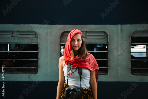 Photography Western female traveler standing at a railway station in Varanasi