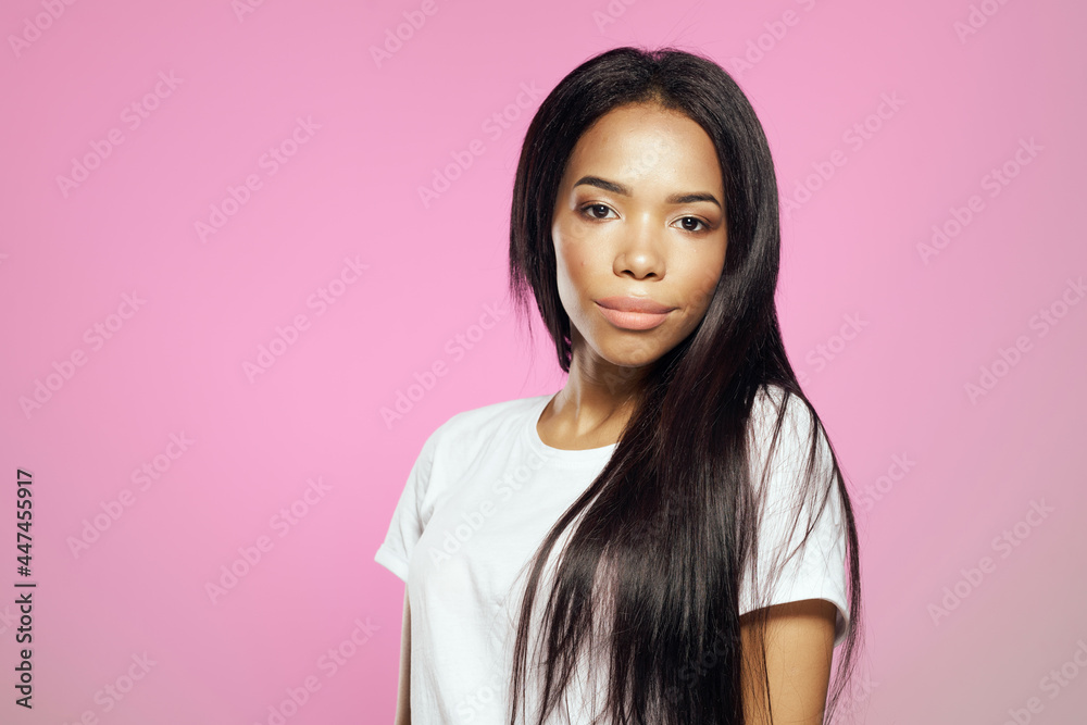 woman of african appearance in white t-shirt fashionable hairstyle posing pink background woman of african appearance in white t-shirt fashionable hairstyle posing pink background
