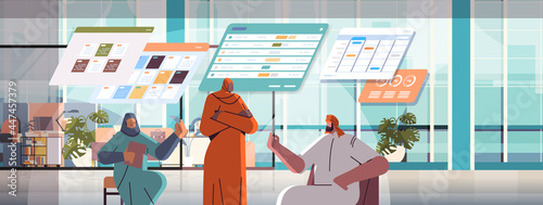 arab businesspeople team analyzing statistic data on virtual boards successful teamwork concept office interior