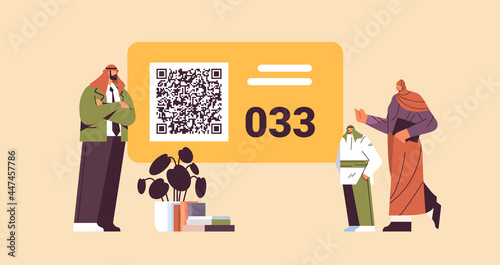 arab people looking at display number board in waiting room electronic queuing system queue management