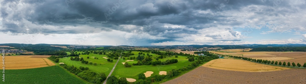 Bird's eye view of a golf course in the Taunus / Germany with threatening thunderstorm clouds Bird's eye view of a golf course in the Taunus / Germany with threatening thunderstorm clouds